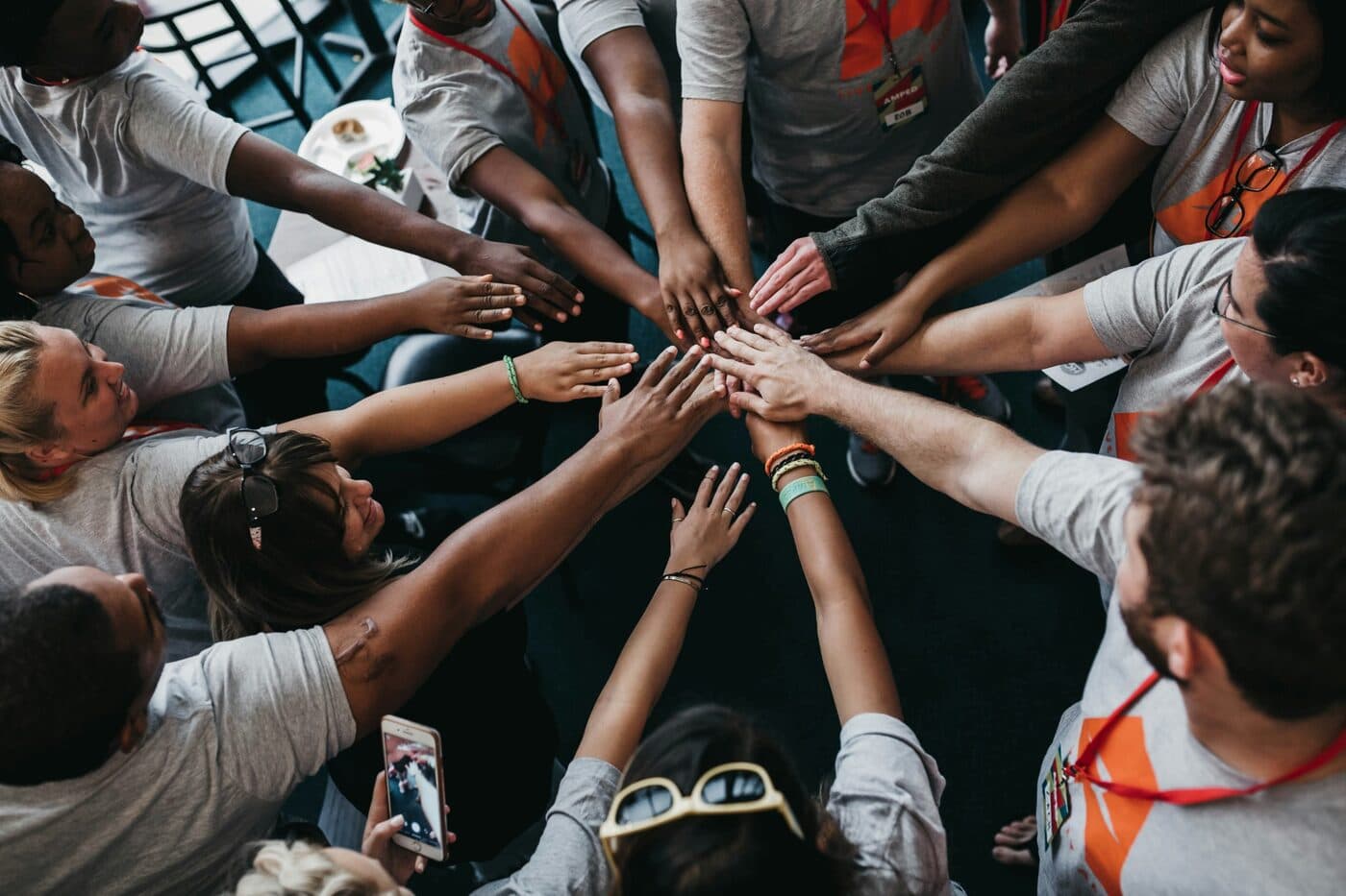 A team joining hands in the middle of a training session