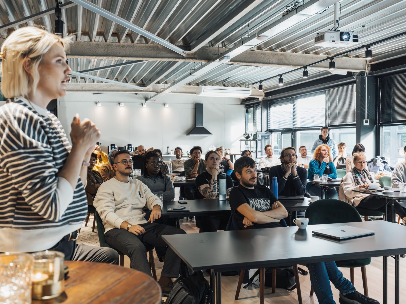 A trainer leading a workshop for a full room of participants